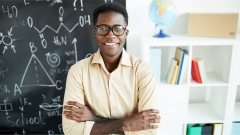 Teacher in front of chalkboard