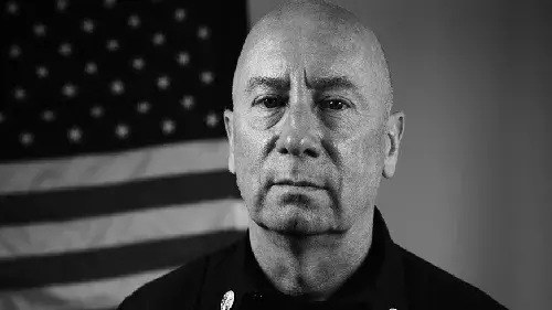 Portrait of firefighter in front of American flag