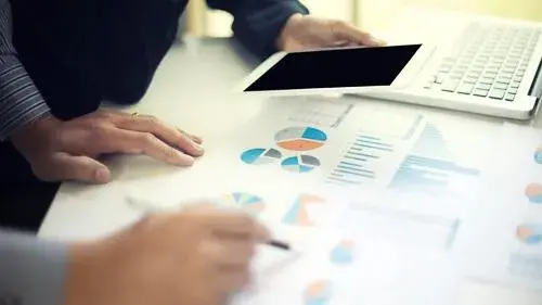 Researchers examining charts and data