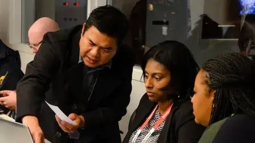 Business workers discussing a paper