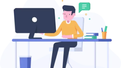 Man sitting at a computer desk looking at a monitor while learning a topic