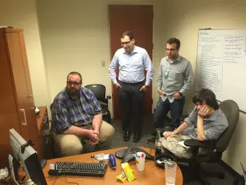 Usability testing at USCIS with two participants, a moderator, and a note taker