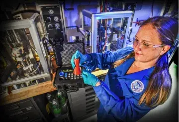 Dr. Alicia Broderick, is using a MD inhaler to deposit a known amount of contraband onto a glass slide
