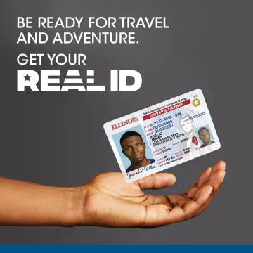 Be Ready for Travel and adventure. Get you REAL ID. Hand holding a Illinos driver's license.