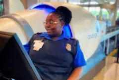 A TSA Transporation Security Officer analyzes baggage using an X-ray machine